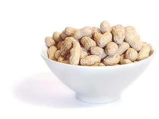 Image showing White bowl with unshelled peanuts