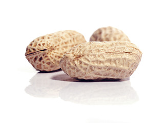 Image showing Three unshelled peanuts