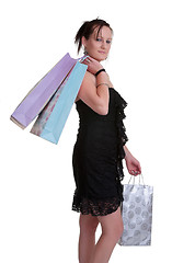 Image showing young woman with shopping bags on white