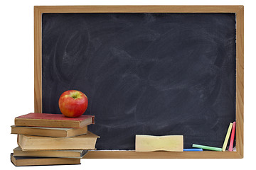 Image showing blackboard with old textbooks and apple