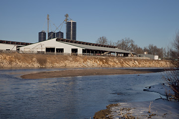 Image showing cattle ranch buildings on river shore