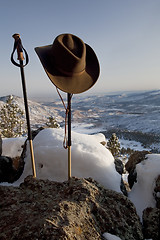 Image showing trekking poles and hat in mountain scenery