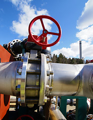 Image showing Industrial zone, Steel pipelines and valves against blue sky