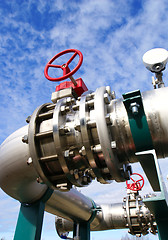 Image showing Industrial zone, Steel pipelines and valves against blue sky