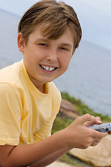 Image showing Child with handheld game