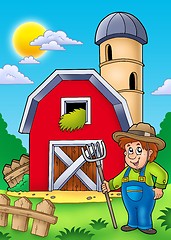 Image showing Big red barn with farmer