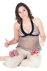 Image showing Portrait of pretty pregnant woman baby shoes