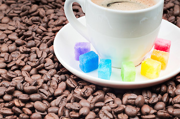 Image showing Multicolored slabs of shugar and cup of coffee