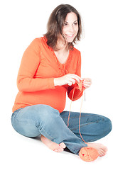 Image showing Portrait of pretty pregnant woman knitting