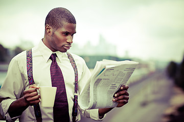 Image showing Businessman reading newspaper