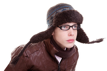 Image showing Young boy looking serious, with winter clothes and hat in the wind