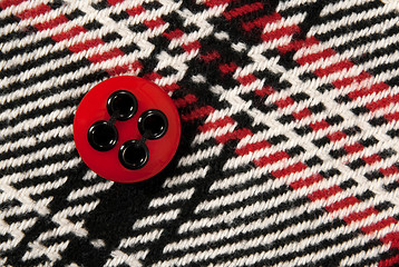 Image showing Red button on checked fabric