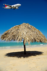 Image showing Parasol on beach and plane