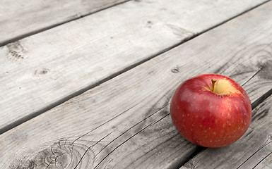 Image showing Red apple on old wooden table