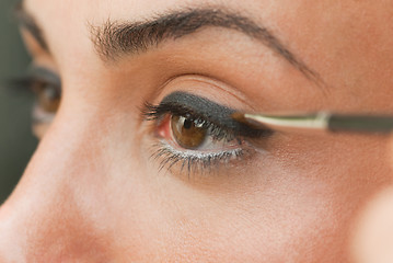 Image showing Girl applying eye make up