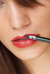 Image showing Woman applying make up