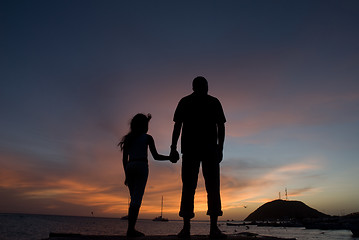 Image showing Father and sun watching sunset