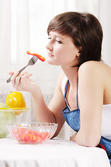 Image showing Housewife eating fresh paprika salad