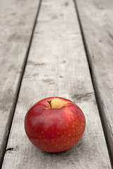 Image showing Ripe red apple on old wooden table