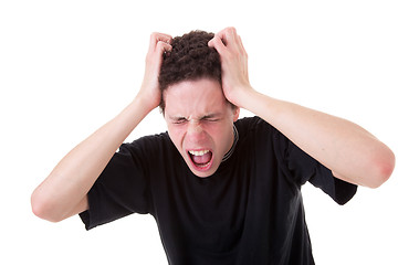 Image showing Strongly afflicted young man, screaming and pulling hair