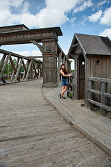 Image showing Beauty girl on old-time bridge.