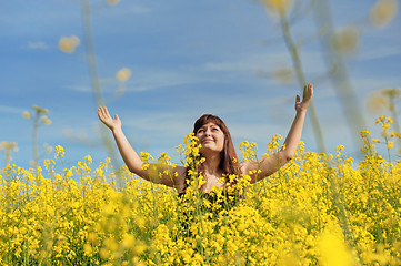 Image showing Happy girl in flower meadow.