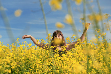 Image showing Happy girl in flower meadow.