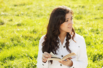 Image showing Brunette in white with book