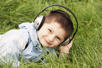 Image showing Cute boy laying in grass