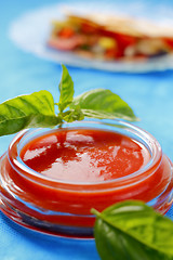 Image showing Tomato sauce with basil leaves