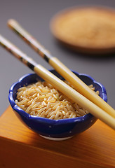 Image showing Brown rice in bowl with chopsticks