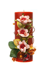 Image showing Large red candle with the flower decoration