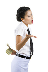 Image showing businesswoman hiding money behind her back