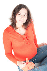 Image showing Portrait of pretty pregnant woman knitting