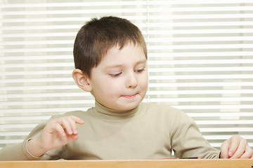 Image showing Cute boy at desk