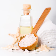 Image showing sea salt on wooden spoon, towel, oil and stars