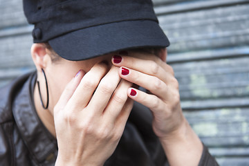 Image showing Sad young woman wearing a cap