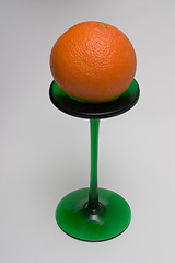 Image showing Orange on a green stand