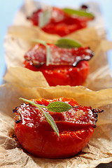 Image showing Fried tomato halves with bacon and sage