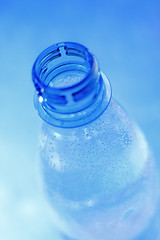 Image showing Open mineral water bottle in blue