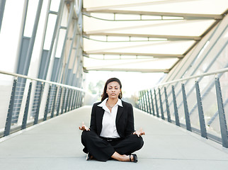 Image showing Black businesswoman meditating