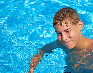 Image showing Smiling boy bright water