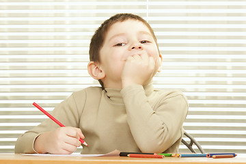 Image showing Contented boy with crayon