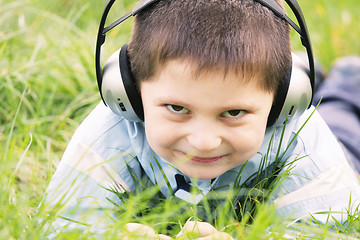 Image showing Smiling boy in headphones outdoors