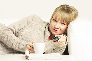 Image showing Woman on sofa with remote control