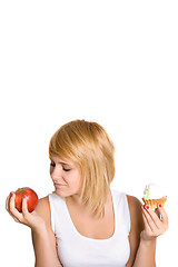 Image showing young woman with cake and apple