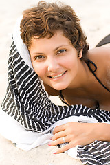 Image showing brunet woman lying on a sand