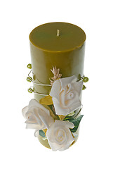 Image showing Large green candle with the flower decoration