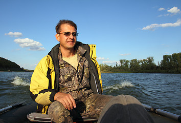 Image showing men on boat with motor