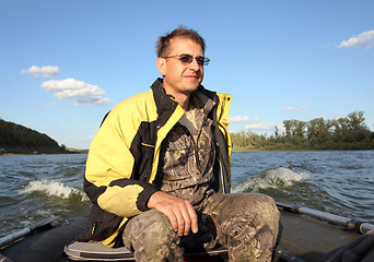 Image showing men on boat with motor